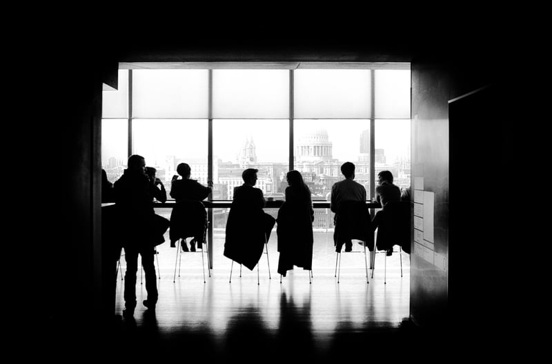 Business leaders in front of a window