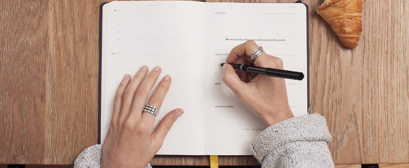 Woman's hands on an emotional intelligence notebook