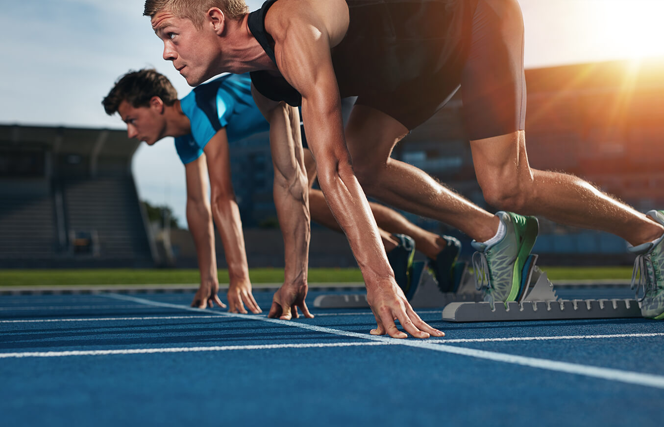 Two Men in Gym Clothing at the Start of a Running Race