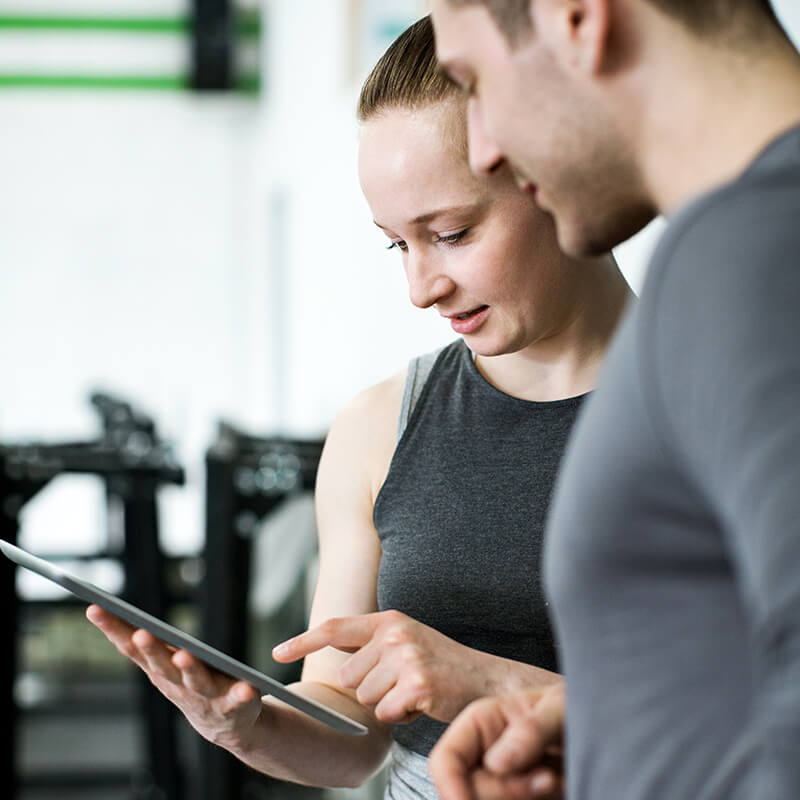 A Man and a Woman Looking at a Tablet