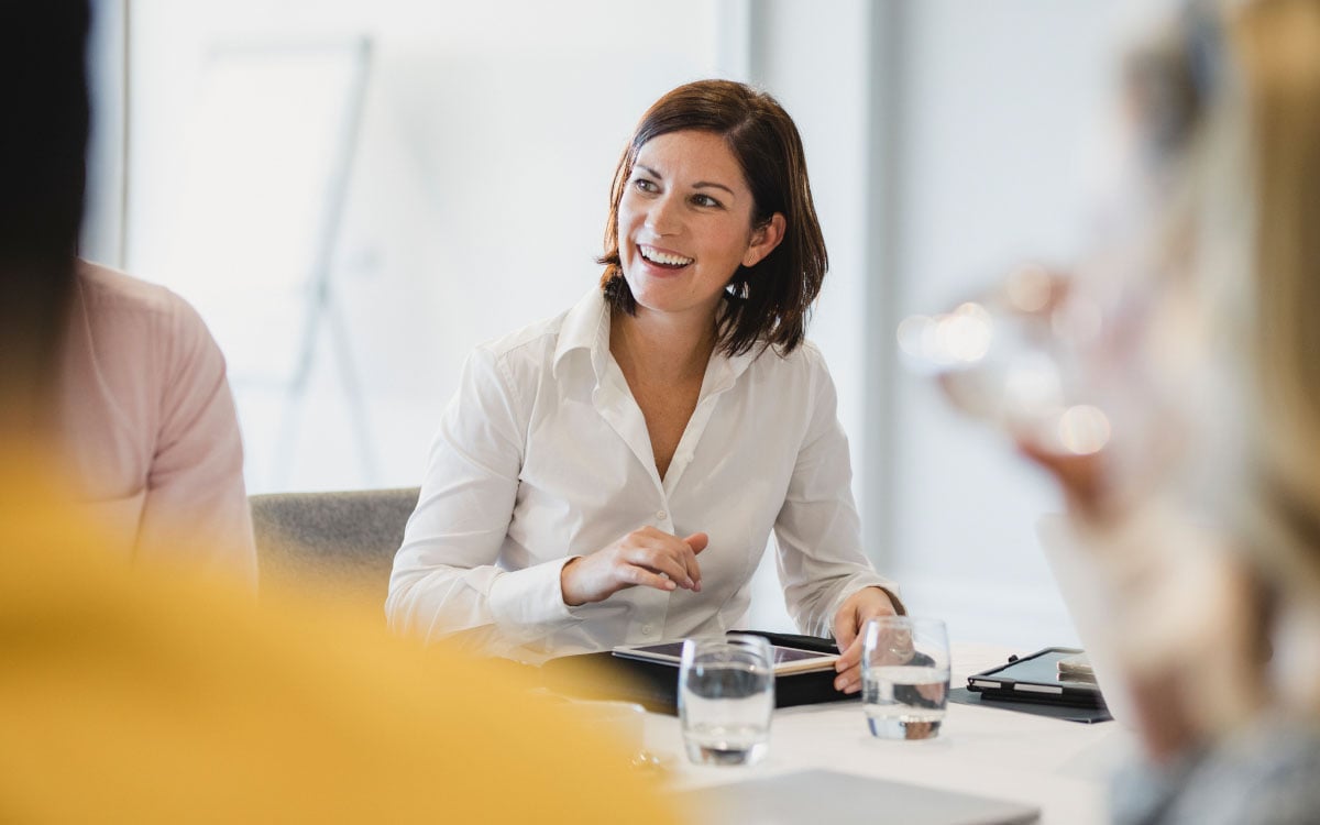 A smiling woman at a table