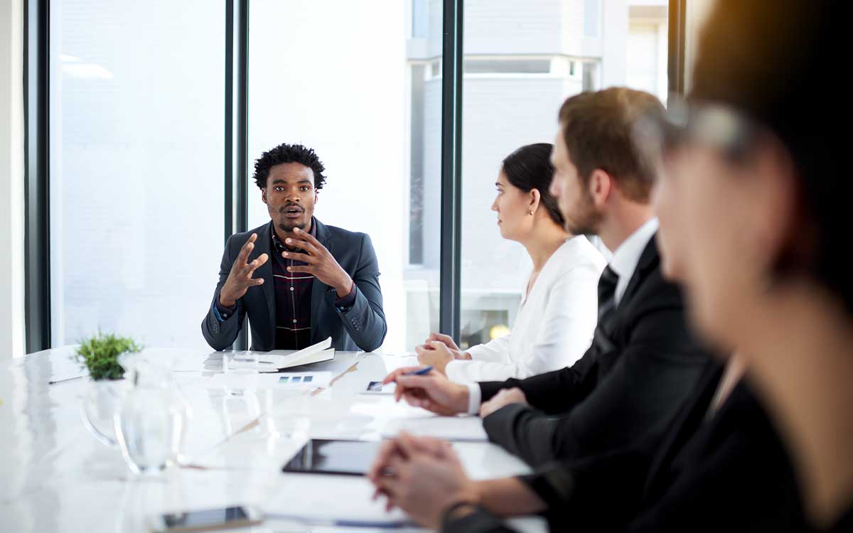 Man talking in a business meeting at a table