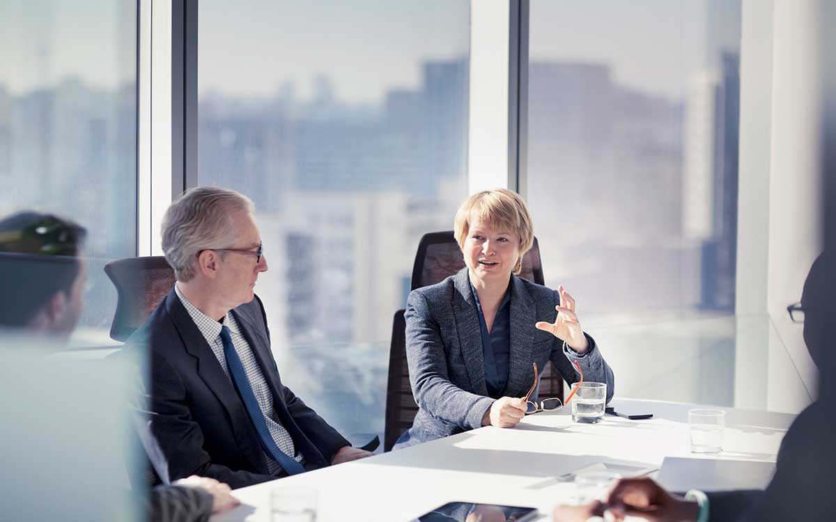 A woman talking in a business meeting at a table